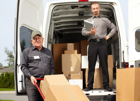 Team reviewing ethical compliance documents for Man And Van Waterloo